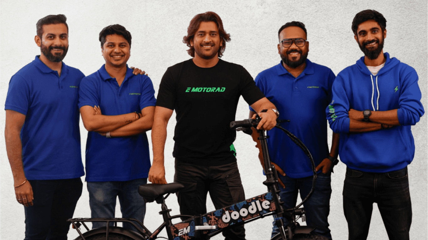 MS Dhoni with EMotorad Team.png